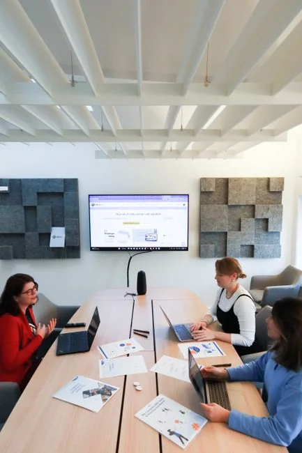 why-choose-us A person reviews stock data using a smartphone and laptop indoors.
